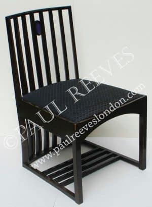 A C.R. Mackintosh chair in black with a slatted back