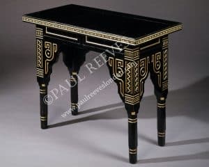 An ebonised and gilded table -0