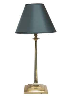 A brass arts and craft lamp, with brass stand and blue grey shade