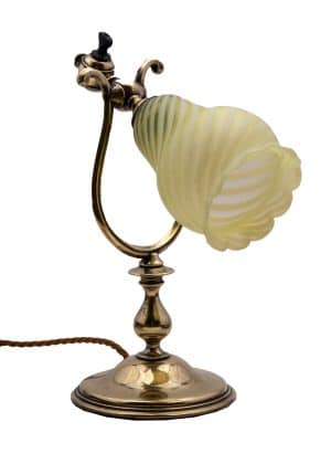 A brass table light in with Jas Powell vaseline glass shade.
